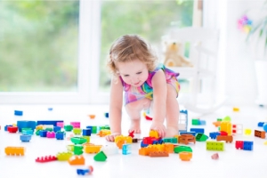 a toddler playing lego toys