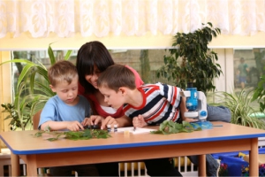 teacher together with her students having an experiment